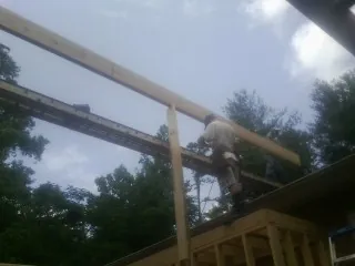 Carpenter setting a ridge beam over a new addition frame — Ice Dam Removal by Roofing Brothers in Agoura Hills